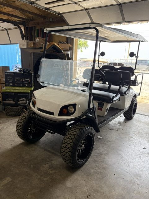 JUST FINISHED 8/21/26 WHITE 2015 CUSTOM FACTORY 6 SEATER ALL NEW BODY, TRIM, BRUSHGUARD, SEATS, MARINE STEREO W/LIGHTED KICKER SPEAKERS, 4" EZGO AXLE LIFT KIT, LIGHTS, 23" TERRAIN TIRES 8/ 6 VOLTS FOR LONGER RUN TIMES ONLY ON FACTORY 6 SEATERS