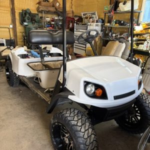 BEING BUILT NOW 8/7/26 WHITE 2015 CUSTOM FACTORY 6 SEATER ALL NEW BODY, TRIM, BRUSHGUARD, SEATS, MARINE STEREO W/LIGHTED KICKER SPEAKERS, 4" EZGO AXLE LIFT KIT, LIGHTS, 23" TERRAIN TIRES 8/ 6 VOLTS FOR LONGER RUN TIMES ONLY ON FACTORY 6 SEATERS