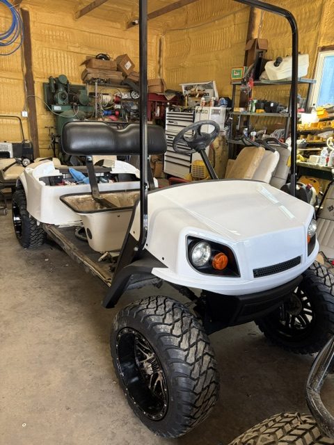 BEING BUILT NOW 8/7/26 WHITE 2015 CUSTOM FACTORY 6 SEATER ALL NEW BODY, TRIM, BRUSHGUARD, SEATS, MARINE STEREO W/LIGHTED KICKER SPEAKERS, 4" EZGO AXLE LIFT KIT, LIGHTS, 23" TERRAIN TIRES 8/ 6 VOLTS FOR LONGER RUN TIMES ONLY ON FACTORY 6 SEATERS